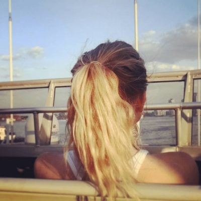 Woman looking out on the city from the top deck of the Seastreak Ferry