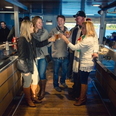 Passengers enjoying beverages inside the ferry