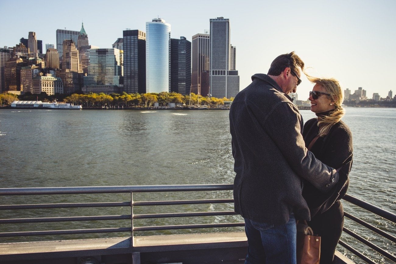 Two passengers on the deck of the ferry as it departs New York