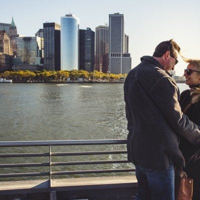Two passengers on the deck of the ferry as it departs New York