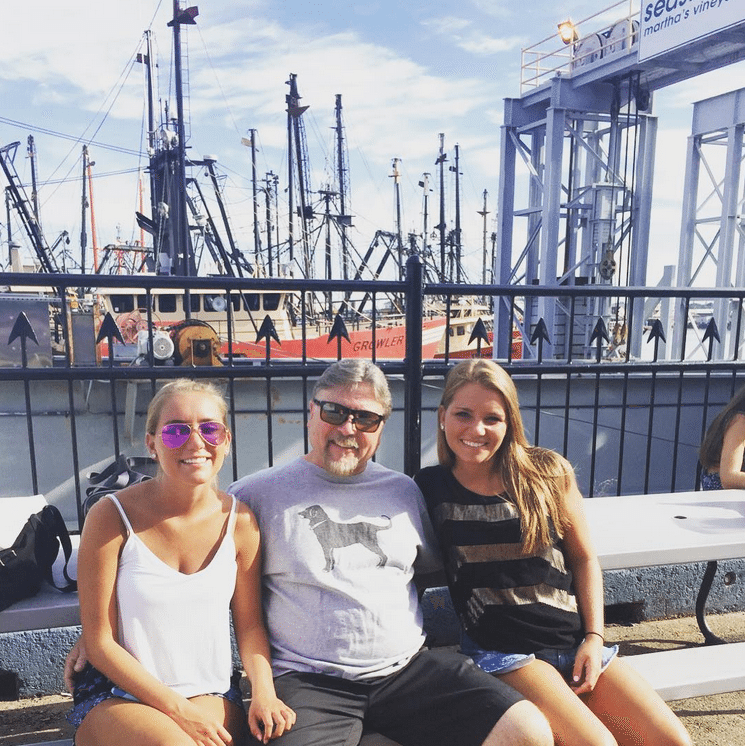 A family sitting on the ferry dock