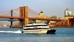 Seastreak Ferry cruising through the harbour with scenic views of New York City behind it.