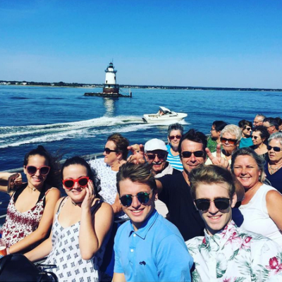 A group of people smiling for the camera on the ferry