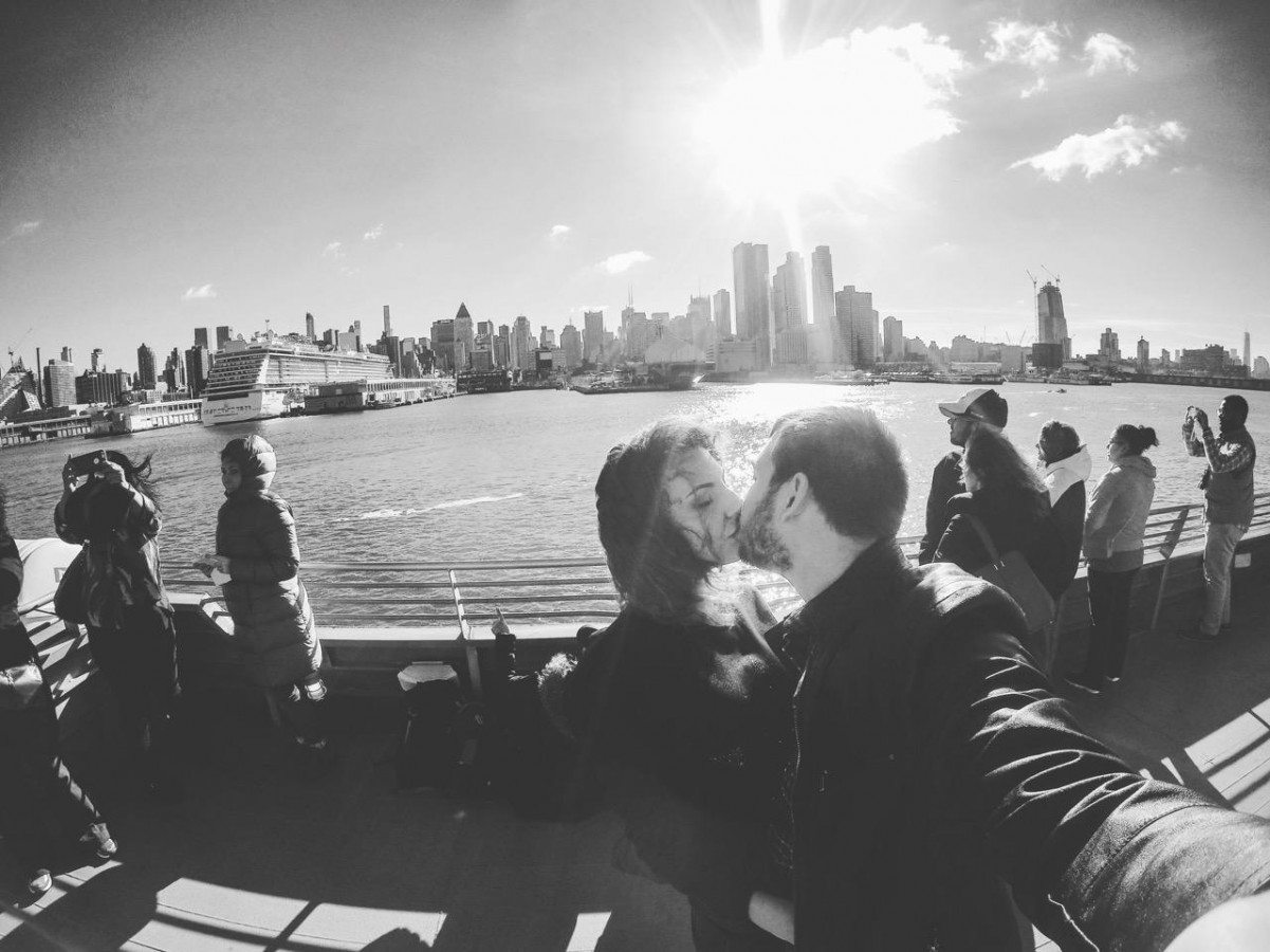 Couple kissing while taking a selfie on the top deck of the Seastreak Ferry