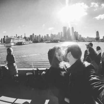 Couple kissing while taking a selfie on the top deck of the Seastreak Ferry