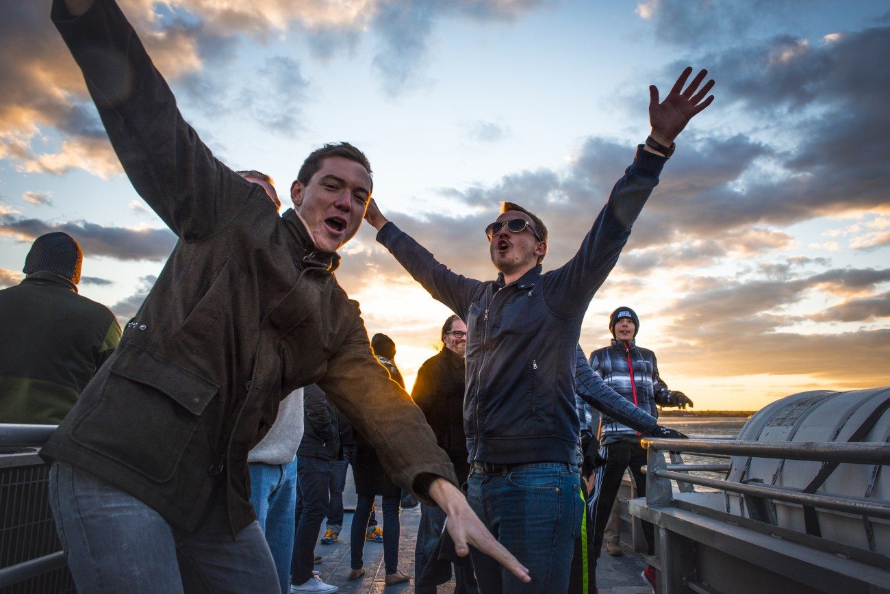 Passengers posing for the camera on the top deck of the ferry