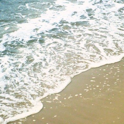 Waves peacfully crashing onto Sandy Hook beach's shore