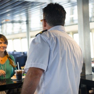 A woman orders food and a drink on the ferry